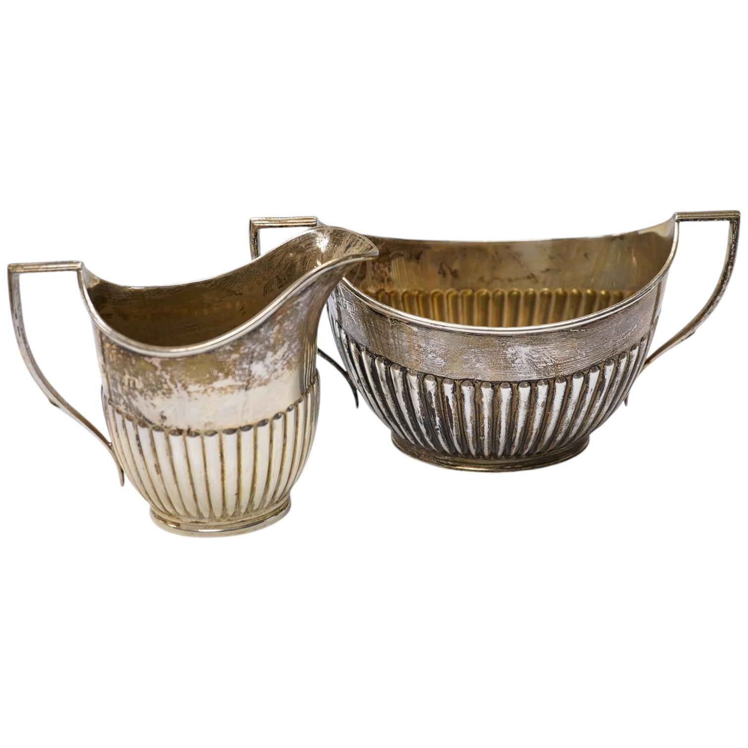 An Edwardian silver half fluted cream jug and two handled sugar bowl, by William Hutton & Sons, London, 1906/7, 11.9oz. Condition - fair